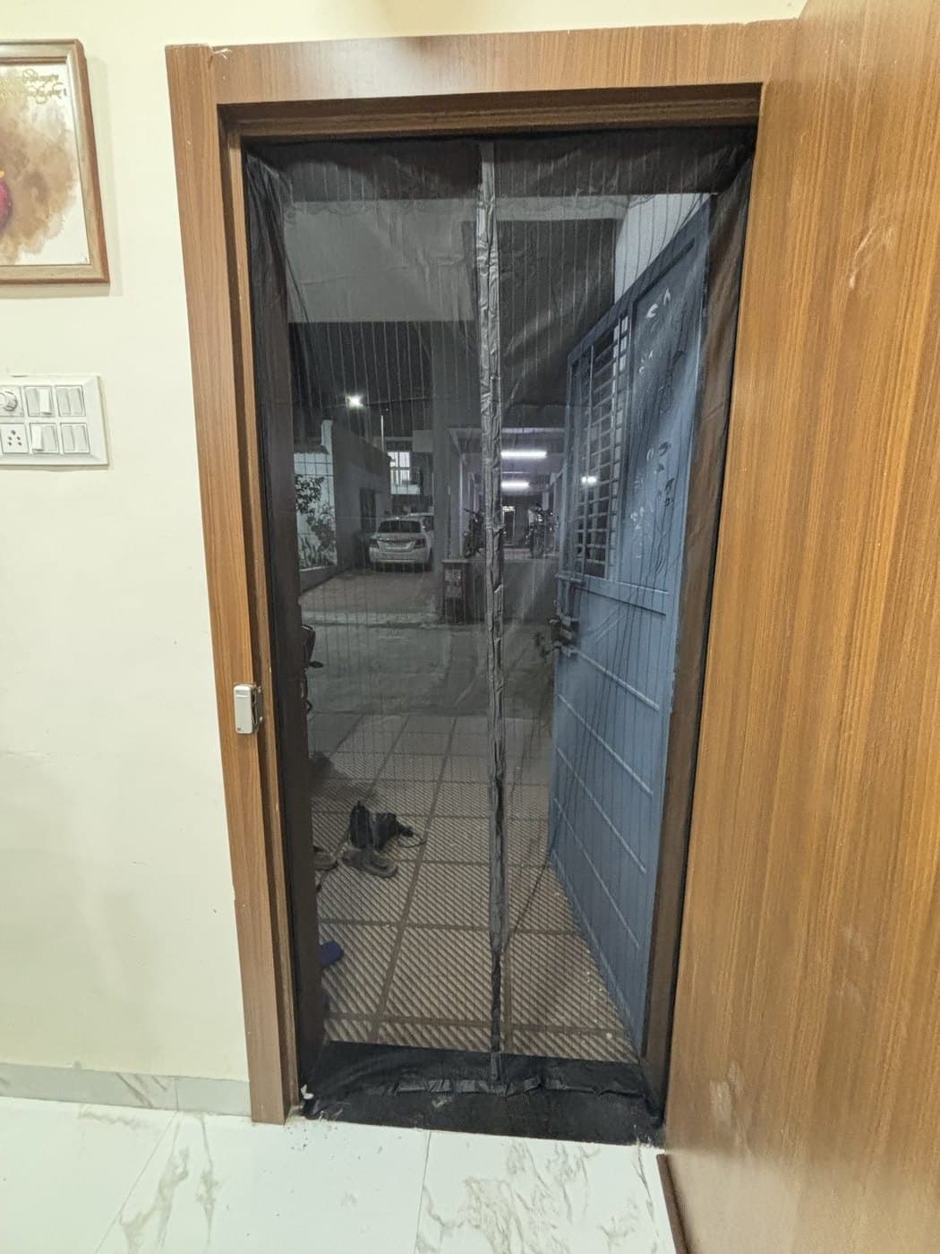 Mosquito door net installed — Wooden door